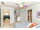 Cozy bedroom featuring a unique ceiling fan, built-in shelving, and access to a second-floor hallway at 13017 Water Ridge Dr, McCordsville, IN 46055