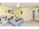 Cheerful bedroom with yellow walls, a comfortable bed, and ample storage space with built-in shelving at 13017 Water Ridge Dr, McCordsville, IN 46055