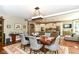 Open-concept dining room with a wooden table, chandelier, and kitchen view at 13017 Water Ridge Dr, McCordsville, IN 46055