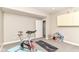 Home gym featuring exercise bike, yoga mat, storage cabinets, and a charming dollhouse at 13017 Water Ridge Dr, McCordsville, IN 46055