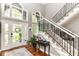 Stunning foyer featuring a staircase, large windows, hardwood floors, and ample natural light at 13017 Water Ridge Dr, McCordsville, IN 46055