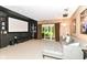 Entertainment room with a large screen, comfortable seating, and sliding glass doors to the outdoors at 13017 Water Ridge Dr, McCordsville, IN 46055