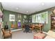 Well-lit office space featuring a wooden desk, comfortable seating, and decorative items on display at 13017 Water Ridge Dr, McCordsville, IN 46055