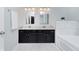 Bathroom featuring double sinks with granite countertops, a black vanity, and tile flooring at 13896 Fernleaf Way, Carmel, IN 46033