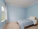 Bedroom with light blue walls, carpet flooring, and a window providing natural light at 13896 Fernleaf Way, Carmel, IN 46033