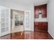 Stylish entryway with hardwood floors, complemented by glass doors and a decorative built-in cabinet at 13896 Fernleaf Way, Carmel, IN 46033