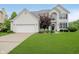 Charming two-story home features an attached two-car garage and a well-manicured lawn at 13896 Fernleaf Way, Carmel, IN 46033