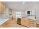 Modern kitchen features white countertops, light wood cabinets, and stainless steel dishwasher at 13896 Fernleaf Way, Carmel, IN 46033