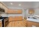 Spacious kitchen with light wood cabinetry, stainless steel appliances, and stylish countertops at 13896 Fernleaf Way, Carmel, IN 46033