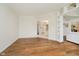 Spacious living room with hardwood floors leading to open kitchen and staircase at 13896 Fernleaf Way, Carmel, IN 46033