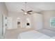 Spacious main bedroom with a ceiling fan, carpet flooring, and multiple closets at 13896 Fernleaf Way, Carmel, IN 46033
