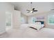 Spacious main bedroom with vaulted ceilings, plush carpeting, and abundant natural light at 13896 Fernleaf Way, Carmel, IN 46033