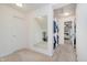 Carpeted walk-in closet with built-in shelving and a full-length mirror at 13896 Fernleaf Way, Carmel, IN 46033