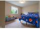 A cozy bedroom with a window and a patterned comforter over the bed at 1452 Brookside N Ct, Columbus, IN 47201