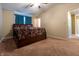 Primary bedroom with a ceiling fan, carpeted floors, and window with curtains at 1452 Brookside N Ct, Columbus, IN 47201