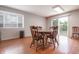 Bright dining area features wood-style flooring and sliding glass door with view to backyard at 1452 Brookside N Ct, Columbus, IN 47201