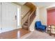 Inviting foyer showcasing hardwood floors, stairs to the upper level, and a bright front door at 1452 Brookside N Ct, Columbus, IN 47201