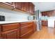 Bright kitchen featuring modern stainless steel appliances and dark cherry cabinets with light countertops at 1452 Brookside N Ct, Columbus, IN 47201