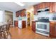 Bright open kitchen with stainless steel appliances, wood cabinets, and modern countertops at 1452 Brookside N Ct, Columbus, IN 47201