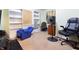 A cozy living room with a blue recliner, white shelves, and carpeted floor at 1452 Brookside N Ct, Columbus, IN 47201