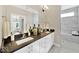 Modern bathroom featuring dual sinks, dark countertops, white cabinetry, and a large framed mirror at 14877 Higgins Dr, Westfield, IN 46074
