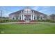 Well-manicured community clubhouse featuring lush landscaping, a covered entry, and ample parking at 14877 Higgins Dr, Westfield, IN 46074
