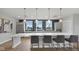 Spacious kitchen island with seating, modern pendant lighting, gray cabinets, and stainless steel appliances at 14877 Higgins Dr, Westfield, IN 46074