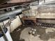 Unfinished basement area with exposed ceiling beams, a workbench and concrete block supports at 1546 Wade St, Indianapolis, IN 46203