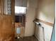 Unfinished bathroom with exposed wall framing, exposed plumbing, and wood door at 1546 Wade St, Indianapolis, IN 46203