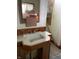 An older bathroom sink with a vintage mirror, tile accents, and a note regarding pipes at 1546 Wade St, Indianapolis, IN 46203