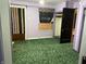 Bedroom with green carpet, purple walls and woodwork plus a window with a decorative valance at 1546 Wade St, Indianapolis, IN 46203