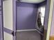 A charming bedroom with lavender walls and an open closet at 1546 Wade St, Indianapolis, IN 46203