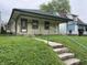 Charming single-story home featuring a welcoming front porch and a well-maintained lawn at 1546 Wade St, Indianapolis, IN 46203