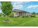 Lush backyard showcasing a well-maintained lawn, mature trees, and a charming screened-in porch at 16071 Prince Ct, Noblesville, IN 46062