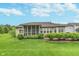 Well-manicured backyard features a screened porch, lush lawn, and tasteful landscaping, perfect for outdoor enjoyment at 16071 Prince Ct, Noblesville, IN 46062