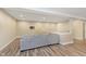 Finished basement with gray L-shaped sofa and wood flooring at 16071 Prince Ct, Noblesville, IN 46062