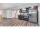 Basement kitchen featuring stainless steel appliances, wood cabinets, and laminate flooring for a sleek and modern look at 16071 Prince Ct, Noblesville, IN 46062