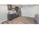 Finished basement features gray cabinets, granite counters, stainless appliances, and wood flooring at 16071 Prince Ct, Noblesville, IN 46062