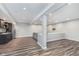 Finished basement with a wet bar, gray couch, and flatscreen TV mount at 16071 Prince Ct, Noblesville, IN 46062