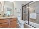 Bright bathroom featuring a shower with glass doors, light wood vanity, and neutral color scheme at 16071 Prince Ct, Noblesville, IN 46062