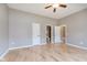 Spacious bedroom with hardwood floors, ceiling fan, and doors to the bathroom and closet at 16071 Prince Ct, Noblesville, IN 46062