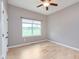 Bedroom with hardwood floors, ceiling fan, large window overlooking the green outdoor view at 16071 Prince Ct, Noblesville, IN 46062