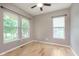 Neutral bedroom featuring hardwood floors, ceiling fan, and natural light streaming through the windows at 16071 Prince Ct, Noblesville, IN 46062