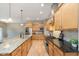 A modern kitchen with granite counters, stainless steel appliances, and wood cabinets at 16071 Prince Ct, Noblesville, IN 46062