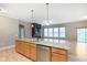 Open living room features a granite kitchen island and gas fireplace at 16071 Prince Ct, Noblesville, IN 46062