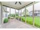 Screened porch overlooking brick patio and fire pit area surrounded by the vibrant green yard at 16071 Prince Ct, Noblesville, IN 46062