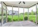 Relaxing screened porch with ceiling fan and view of the lush, expansive backyard and neighboring home at 16071 Prince Ct, Noblesville, IN 46062