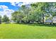 Large, grassy backyard surrounded by mature trees, offering a serene outdoor space at 16316 Brookhollow Dr, Westfield, IN 46074