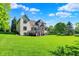 Lush backyard with a well-maintained lawn and mature trees, offering a private and serene outdoor space at 16316 Brookhollow Dr, Westfield, IN 46074