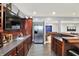 Open bar area featuring sleek countertops, stainless steel appliances, and seamless transition to living space at 16316 Brookhollow Dr, Westfield, IN 46074